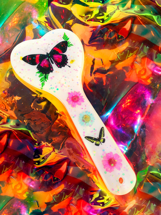Heart shaped resin spanking paddle made of resin, flowers, butterflies and glitter