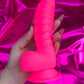 Neon pink silicone devil dildo with suction cup. 