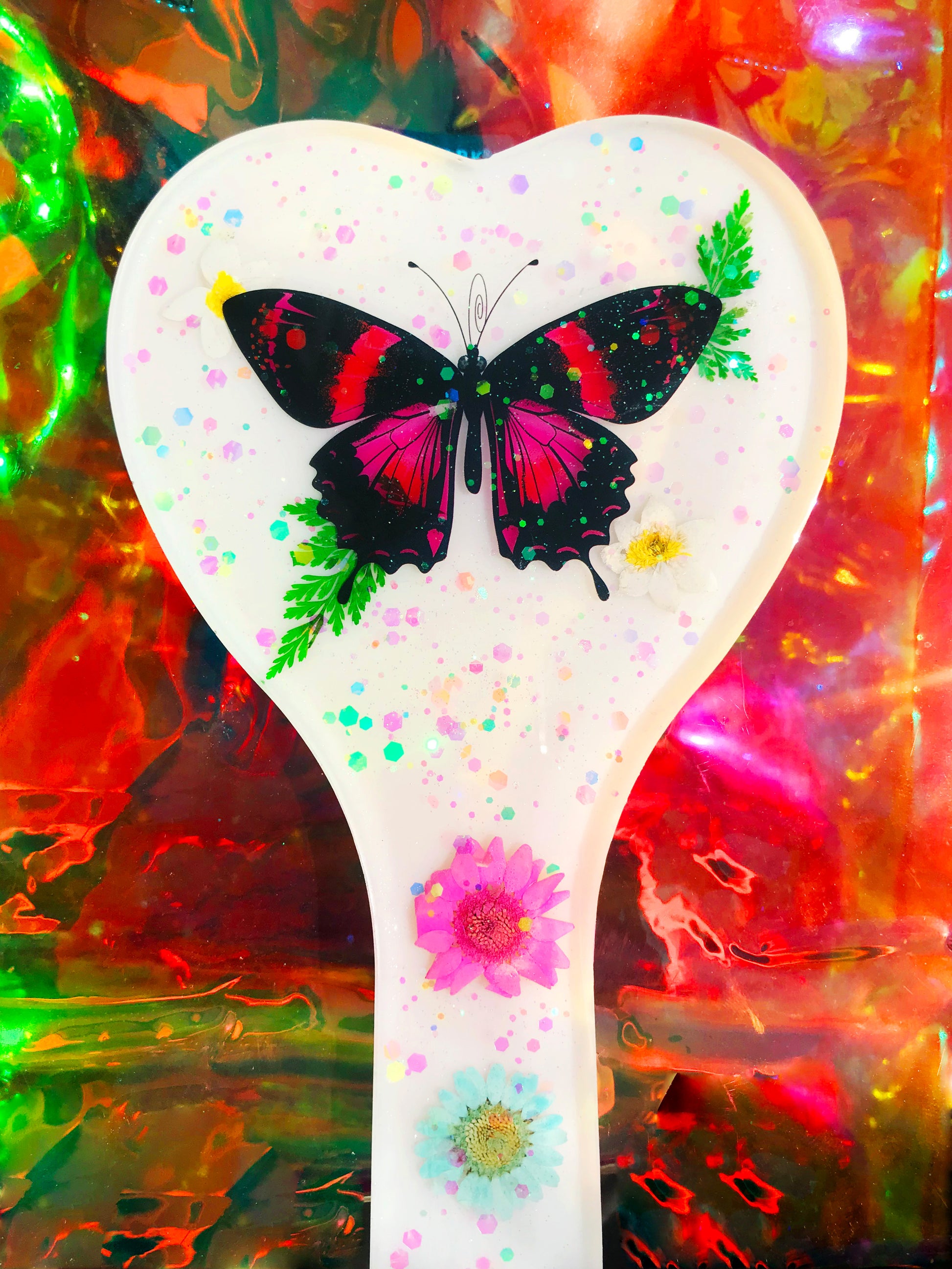 Heart shaped resin spanking paddle made of resin, flowers, butterflies and glitter