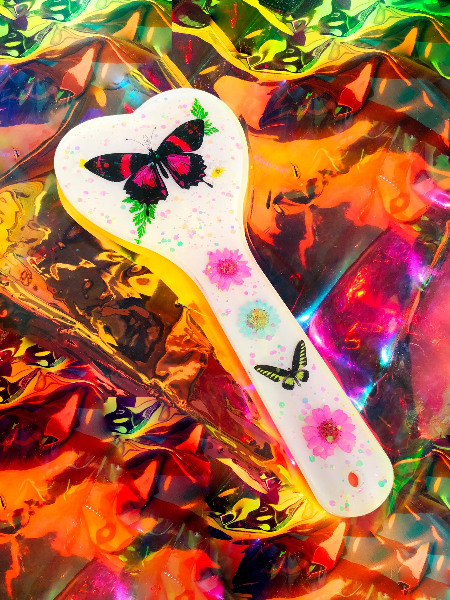 Heart shaped resin spanking paddle made of resin, flowers, butterflies and glitter