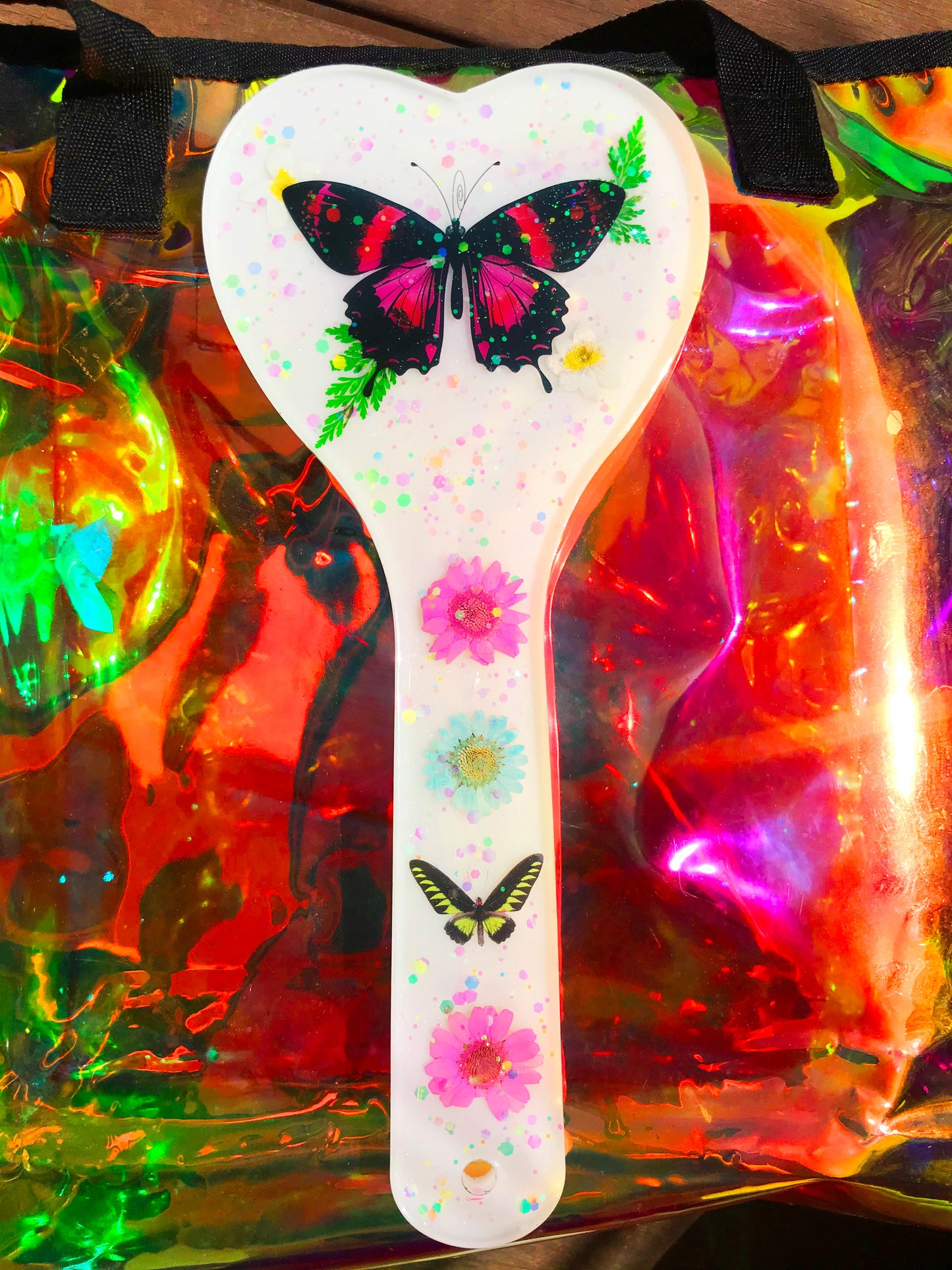 Heart shaped resin spanking paddle made of resin, flowers, butterflies and glitter