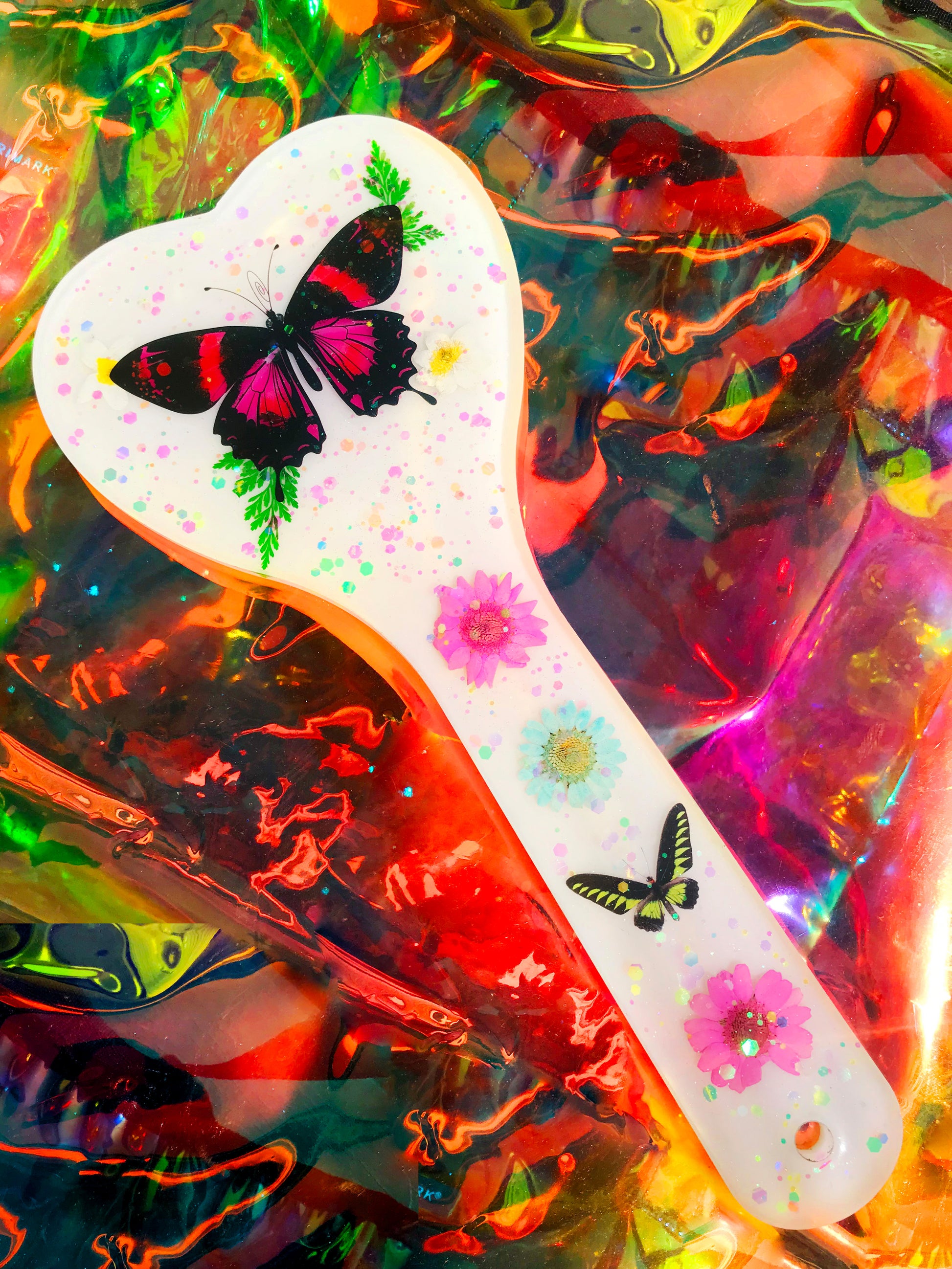 Heart shaped resin spanking paddle made of resin, flowers, butterflies and glitter