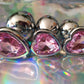 Heart shaped pink jewel butt plug. Black or silver stainless steel butt plug. 