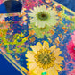 Resin spanking paddle with dried flowers, gold flakes and glitter holographic paper